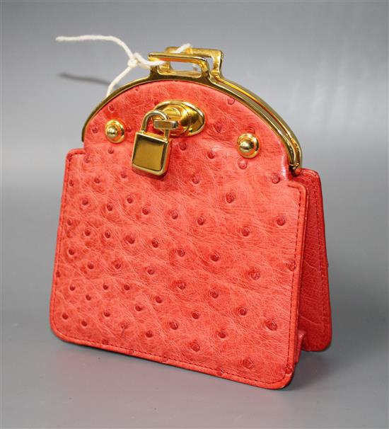 An Asprey red ostrich skin clutch purse, with gilt metal mount and padlock clasp, width 11cm height 12.5cm